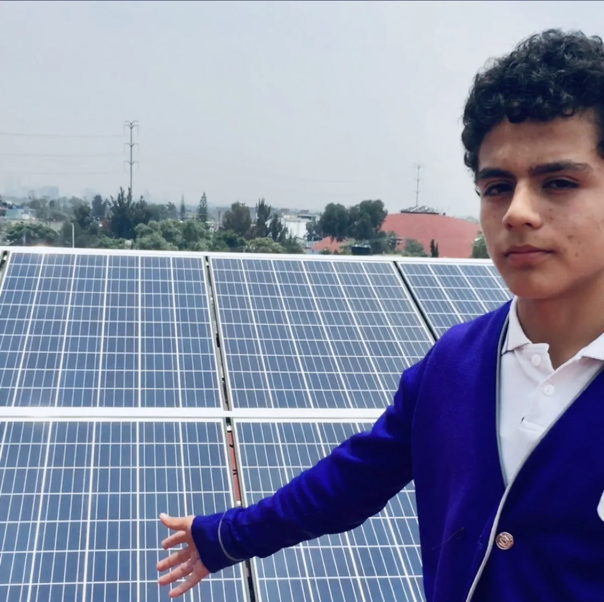 Alumno de Colegio Banting junto a paneles solares del campus en Coyoacán